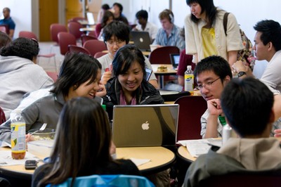 Student studying around a laptop