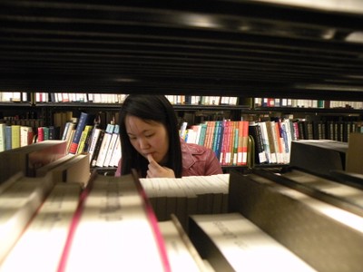 Woman standing in stacks