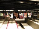 Woman standing in stacks